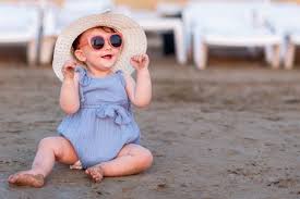 Baby wearing a light cotton onesie in the summer sun