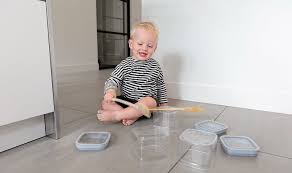 Baby playing with simple household items as toys