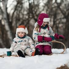 Baby bundled in winter layers with a cozy hat and mittens