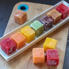 Ice cube tray filled with colorful purees