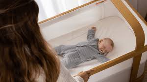 Parent rocking baby as part of a bedtime routine.
