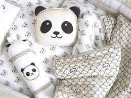 Soft cotton baby crib bedding in neutral colors with plush blanket and toy