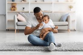 Father bottle-feeding his baby alone in a public space