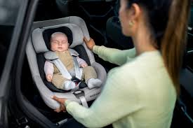 Baby secured with a five-point harness in a car seat