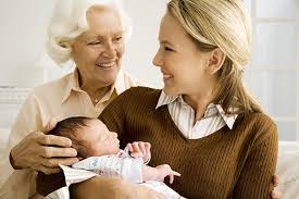 Supportive family helping new mom care for newborn