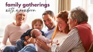 Extended family gathered around a newborn baby with joyful expressions