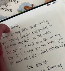 Woman writing a baby poem in a notebook with a soft toy on the table