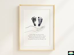Framed baby poem with soft lighting and baby shoes nearby