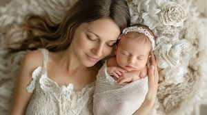 New mother holding newborn baby with affection