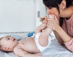 Parent applying olive oil to prevent diaper rash