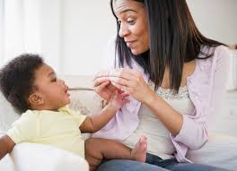 Mom teaching baby sign language